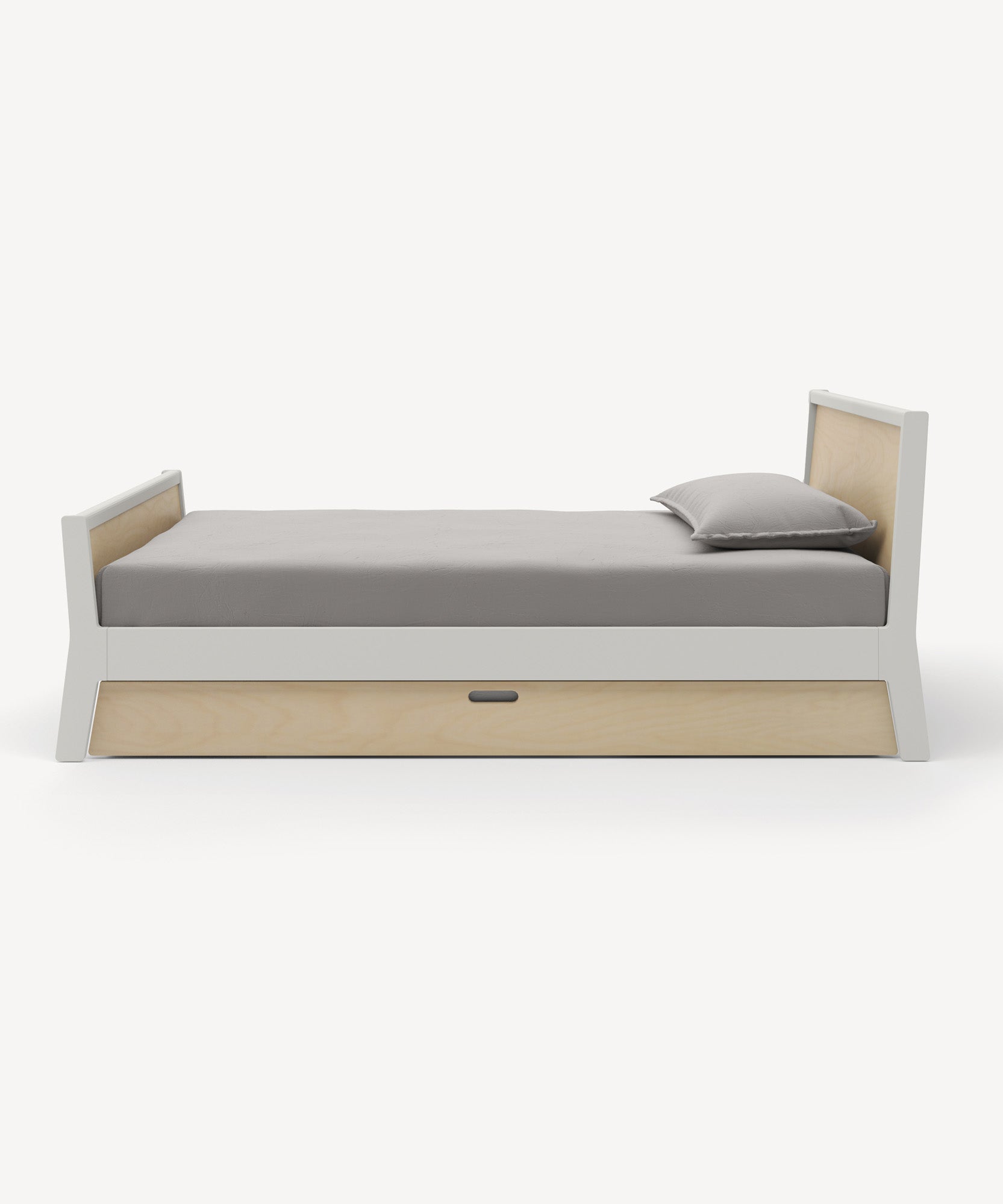 The Sparrow Trundle Bed is a modern single bed with a light wood frame, gray mattress and pillow, plus a storage drawer underneath.