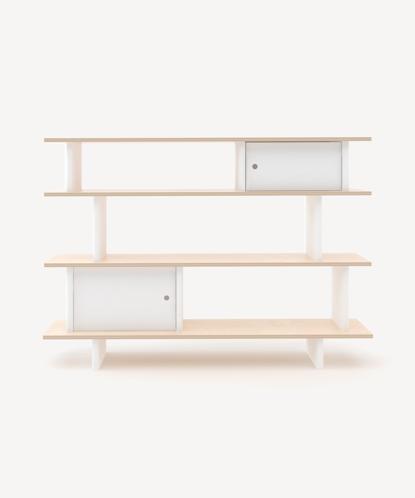 The Mini Library is a minimalist light wood shelf featuring three tiers and sliding white doors on two shelves, set against a plain background.