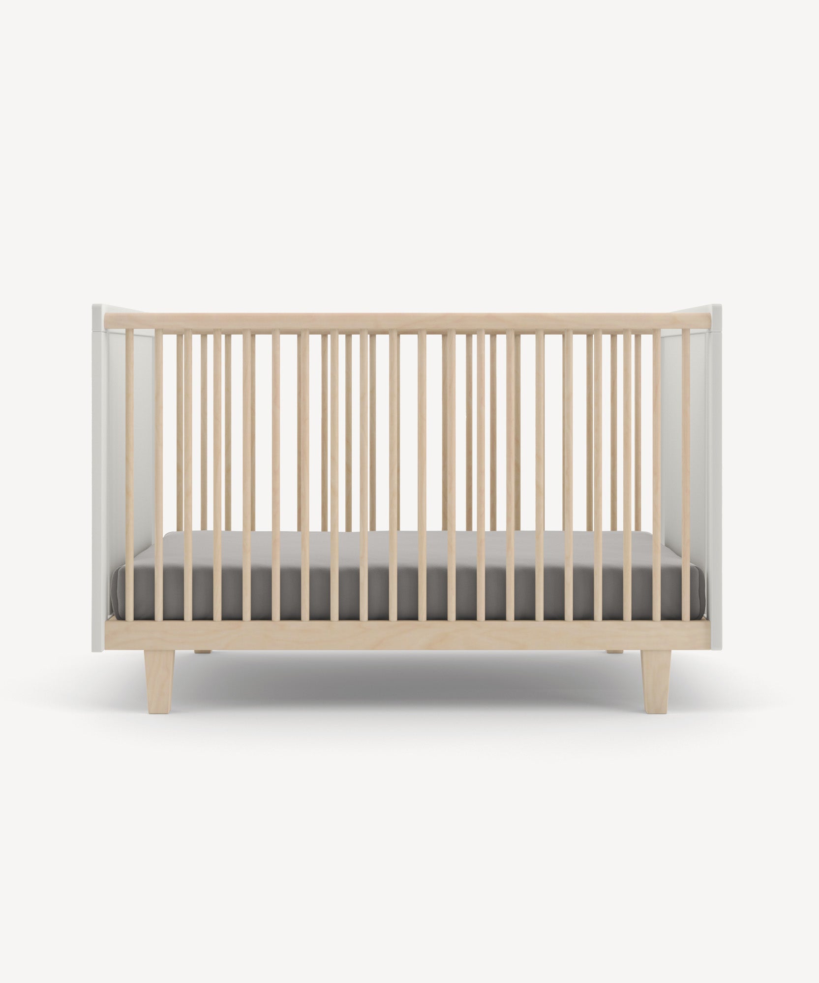 The Rhea Crib features wooden vertical slats and comes with a gray mattress, set against a light background.