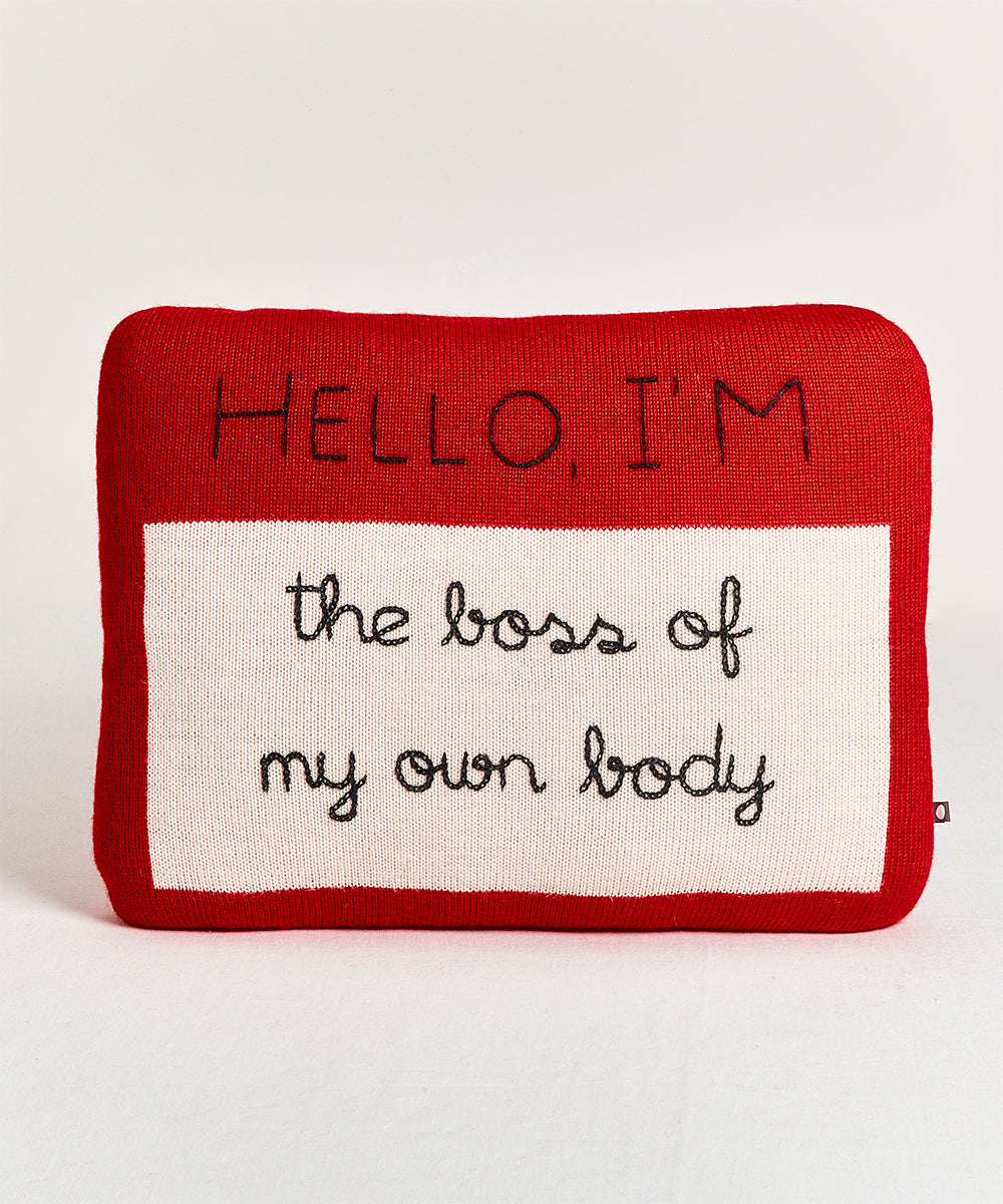 A Name Tag Pillow featuring "Hello, I'm the boss of my own body" on a red background.