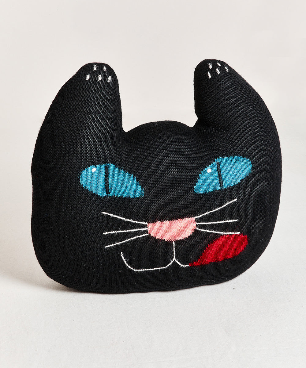 Black Cat Pillow featuring blue eyes, a pink nose, and a red tongue sticking out, shown on a plain light background.