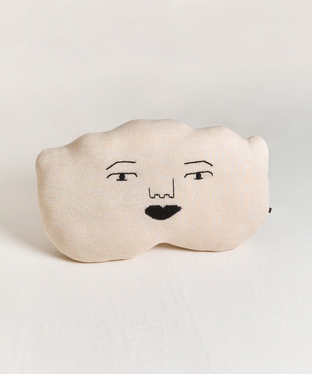 Cloud Pillow in beige with a minimalist face pattern.